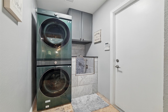 5243 Welden Ct, Fort Worth, TX 76132 - laundry area with visible vents, cabinet space, and stacked washer / dryer