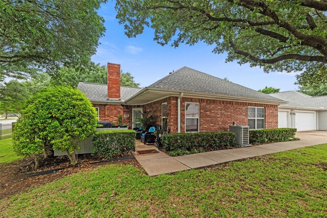 5243 Welden Ct, Fort Worth, TX 76132 - single story home featuring central AC, a chimney, brick siding, a shingled roof, and an attached garage