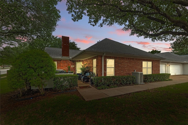 5243 Welden Ct, Fort Worth, TX 76132 - ranch-style home featuring a chimney, brick siding, an attached garage, central air condition unit, and driveway