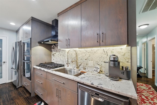 5243 Welden Ct, Fort Worth, TX 76132 - kitchen with wall chimney range hood, visible vents, appliances with stainless steel finishes, a sink, and dark wood-style floors