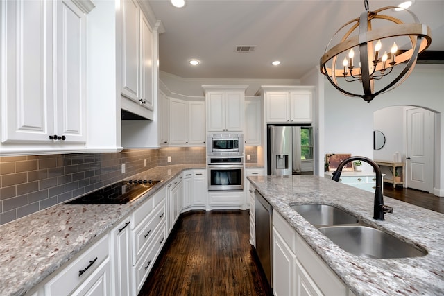235 Winchester St, Van Alstyne, TX 75495 - kitchen featuring stainless steel appliances, white cabinetry, a sink, and dark wood-type flooring