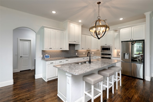 235 Winchester St, Van Alstyne, TX 75495 - kitchen featuring an inviting chandelier, white cabinets, a sink, backsplash, and stainless steel appliances