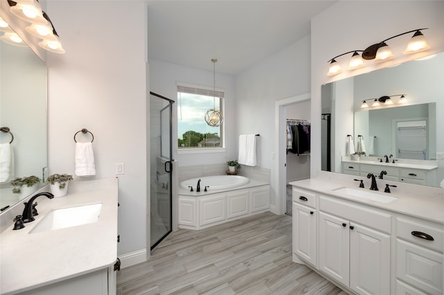 235 Winchester St, Van Alstyne, TX 75495 - full bathroom with two vanities, a shower stall, a sink, and a garden tub