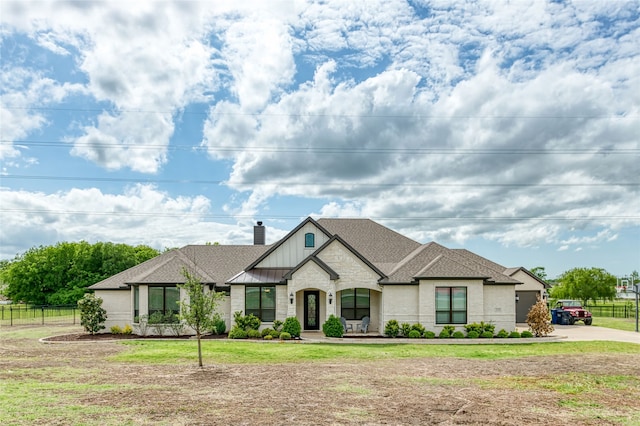 235 Winchester St, Van Alstyne, TX 75495 - french country style house with fence, board and batten siding, a chimney, and driveway