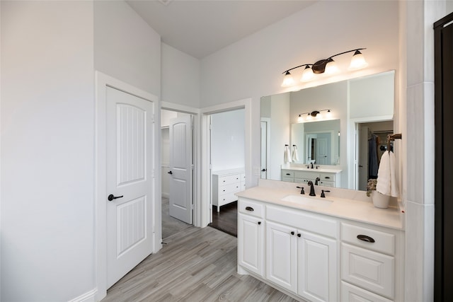 235 Winchester St, Van Alstyne, TX 75495 - bathroom with a spacious closet, wood finished floors, and vanity