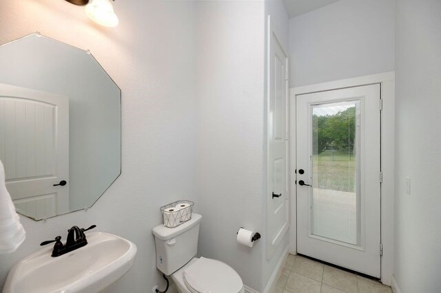 235 Winchester St, Van Alstyne, TX 75495 - bathroom with toilet, tile patterned floors, and a sink