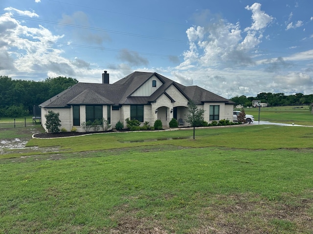 235 Winchester St, Van Alstyne, TX 75495 - french country inspired facade with a front lawn, board and batten siding, fence, and a chimney