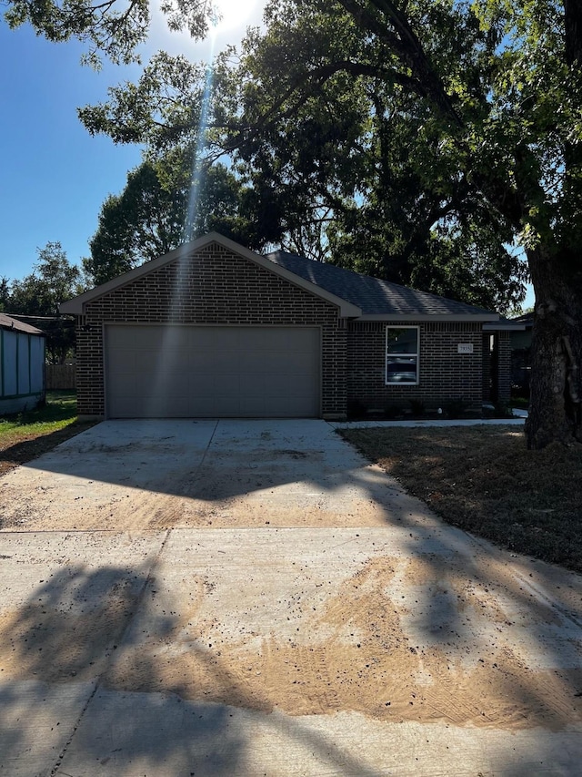 7935 Hull Ave, Dallas, TX 75216 - ranch-style home with an attached garage, concrete driveway, and brick siding