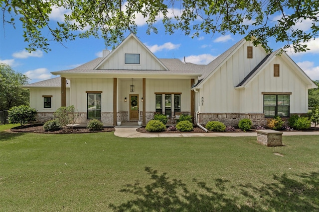 modern farmhouse with board and batten siding, a shingled roof, and a front yard
