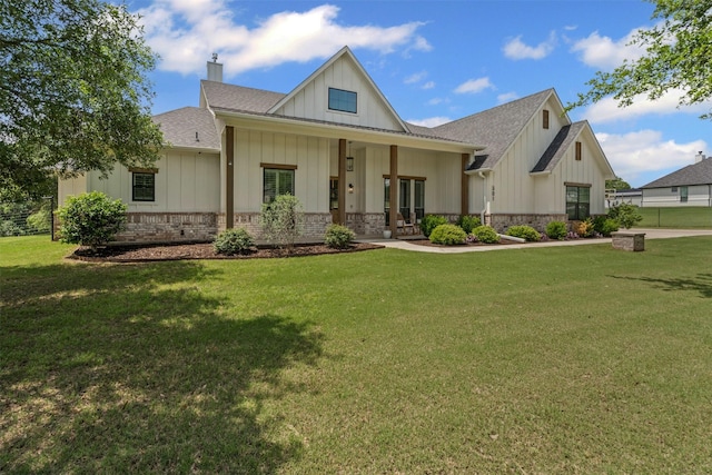 modern inspired farmhouse featuring board and batten siding, a shingled roof, a front lawn, and a chimney