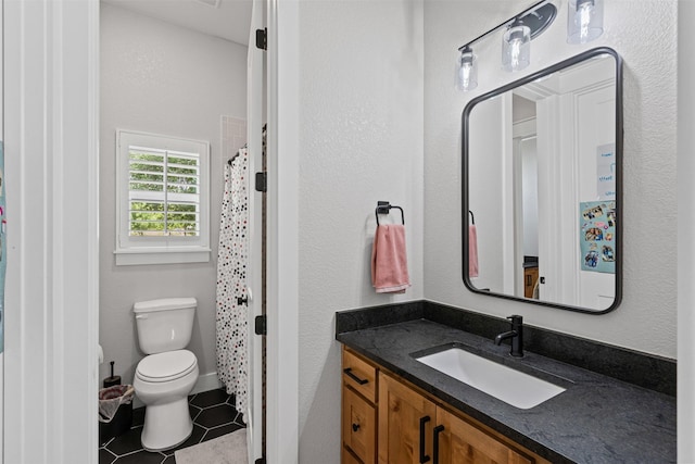bathroom with vanity, a shower with shower curtain, tile patterned floors, and toilet