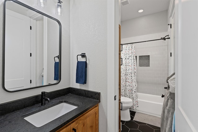 bathroom with tile patterned flooring, shower / bath combo with shower curtain, visible vents, vanity, and toilet