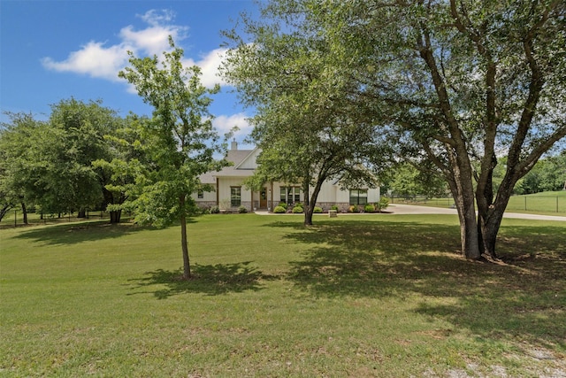 view of front of house with a chimney and a front lawn