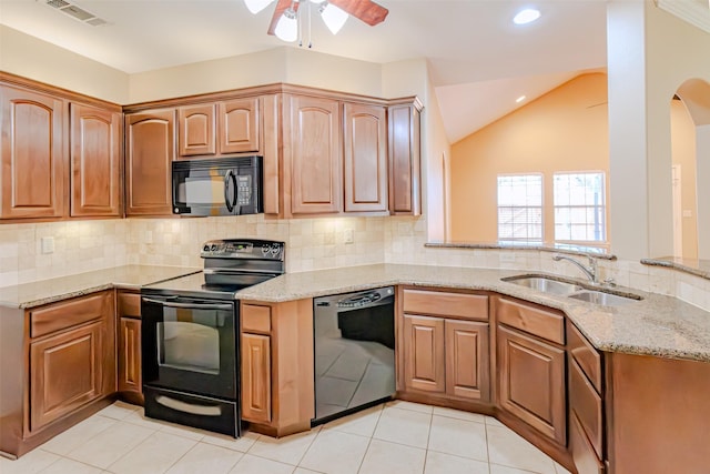kitchen with visible vents, a ceiling fan, light stone counters, a sink, and black appliances