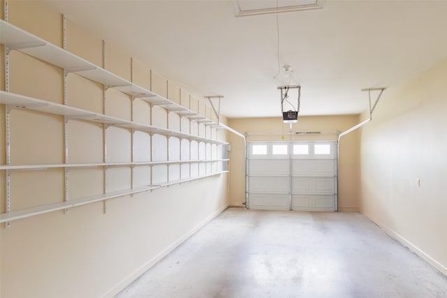 garage with baseboards and a garage door opener
