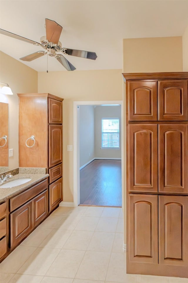 bathroom featuring baseboards, ceiling fan, tile patterned floors, and vanity