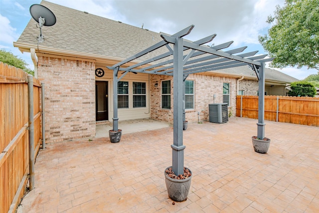 view of patio with a pergola, central AC unit, and a fenced backyard