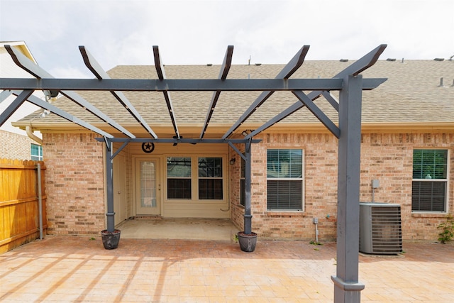 view of patio featuring central AC unit and fence