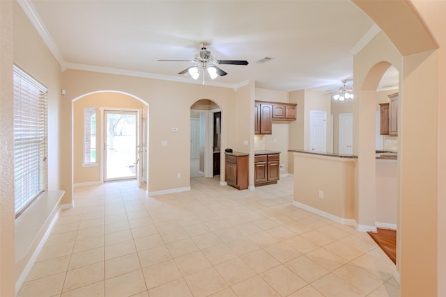 unfurnished living room featuring ornamental molding, a ceiling fan, light tile patterned flooring, and visible vents