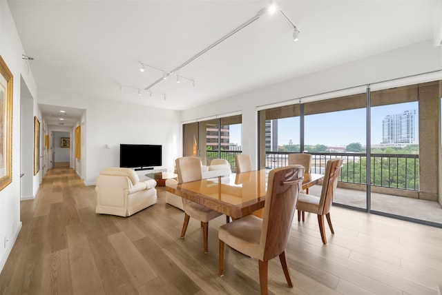 3831 Turtle Creek Blvd Unit 7E, Dallas, TX 75219 - dining area featuring track lighting and light wood-style flooring