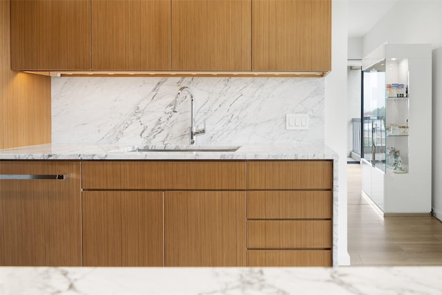 3831 Turtle Creek Blvd Unit 7E, Dallas, TX 75219 - kitchen with a sink, light stone counters, tasteful backsplash, and modern cabinets