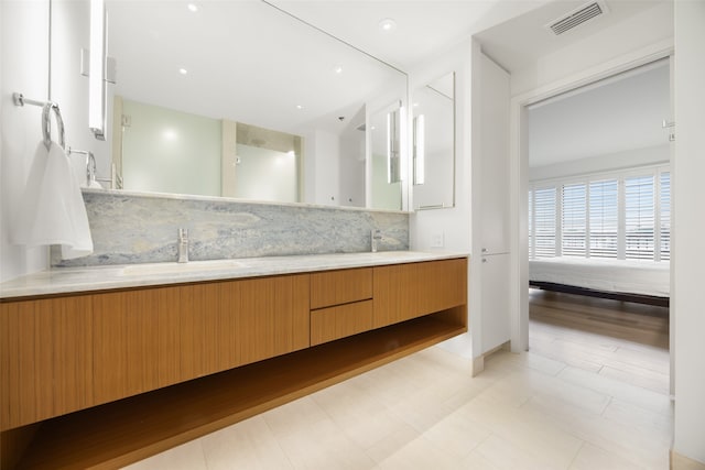 3831 Turtle Creek Blvd Unit 7E, Dallas, TX 75219 - bathroom featuring double vanity, tasteful backsplash, a sink, and visible vents