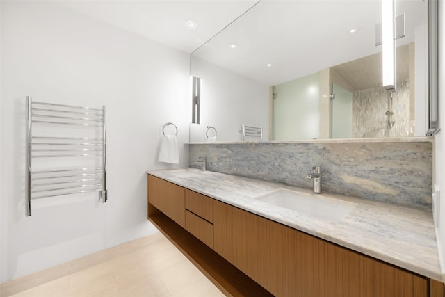 3831 Turtle Creek Blvd Unit 7E, Dallas, TX 75219 - full bathroom with double vanity, walk in shower, a sink, and radiator