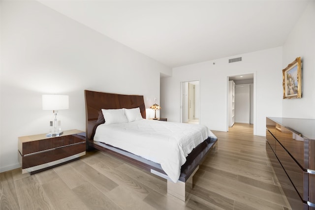 3831 Turtle Creek Blvd Unit 7E, Dallas, TX 75219 - bedroom with visible vents and light wood finished floors