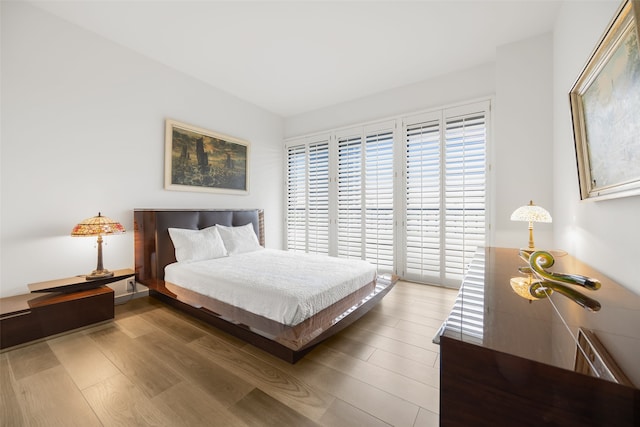 3831 Turtle Creek Blvd Unit 7E, Dallas, TX 75219 - bedroom featuring wood finished floors