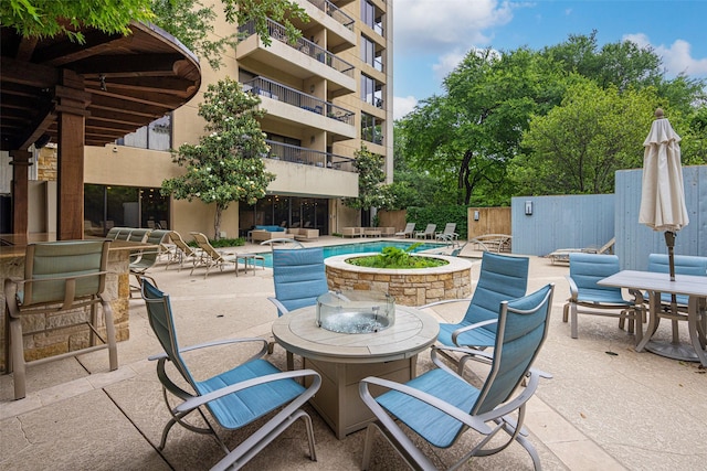 3831 Turtle Creek Blvd Unit 7E, Dallas, TX 75219 - view of patio / terrace with a community pool and outdoor dining space
