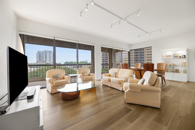 3831 Turtle Creek Blvd Unit 7E, Dallas, TX 75219 - living area with rail lighting and wood finished floors