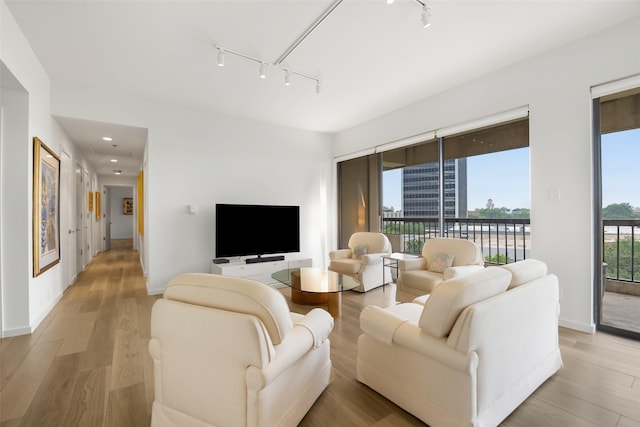 3831 Turtle Creek Blvd Unit 7E, Dallas, TX 75219 - living room with light wood-style floors, track lighting, baseboards, and recessed lighting
