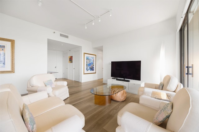 3831 Turtle Creek Blvd Unit 7E, Dallas, TX 75219 - living area featuring visible vents, wood finished floors, and track lighting