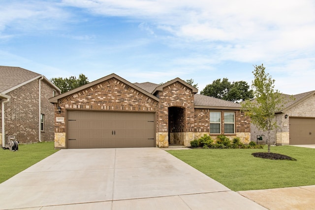 4016 Glastonbury Rd, Mckinney, TX 75071 - view of front of home with an attached garage, concrete driveway, a front lawn, and brick siding