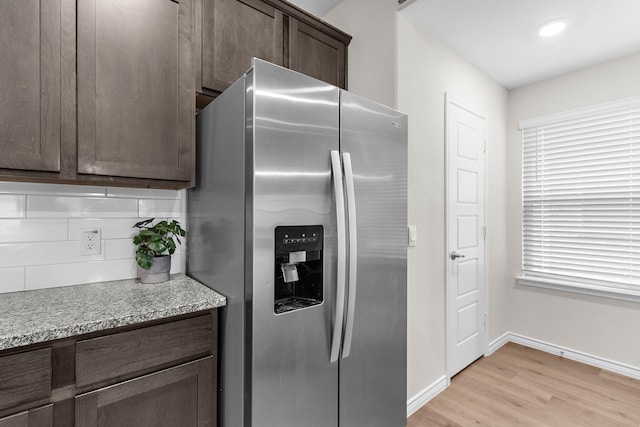 4016 Glastonbury Rd, Mckinney, TX 75071 - kitchen with dark brown cabinetry, baseboards, stainless steel fridge, tasteful backsplash, and light wood finished floors