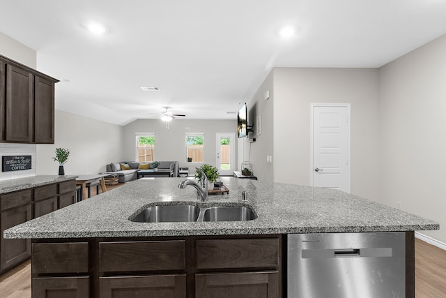 4016 Glastonbury Rd, Mckinney, TX 75071 - kitchen featuring a kitchen island with sink, dark brown cabinets, a sink, light wood-style flooring, and dishwasher