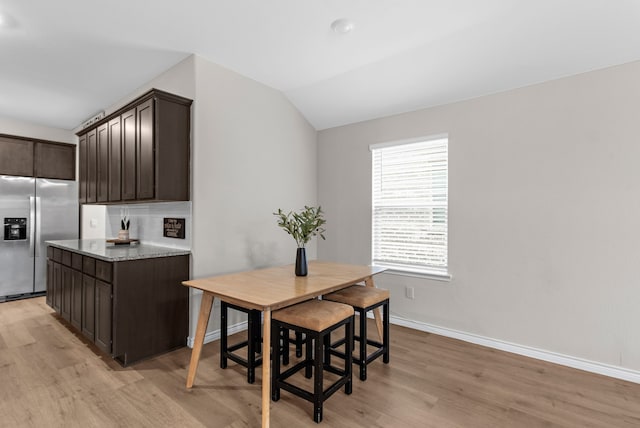 4016 Glastonbury Rd, Mckinney, TX 75071 - dining area featuring baseboards, lofted ceiling, and light wood-style floors