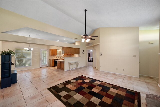 kitchen featuring light tile patterned floors, brown cabinets, open floor plan, a chandelier, and light countertops
