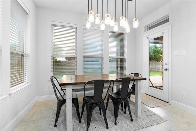 dining area featuring baseboards and a chandelier
