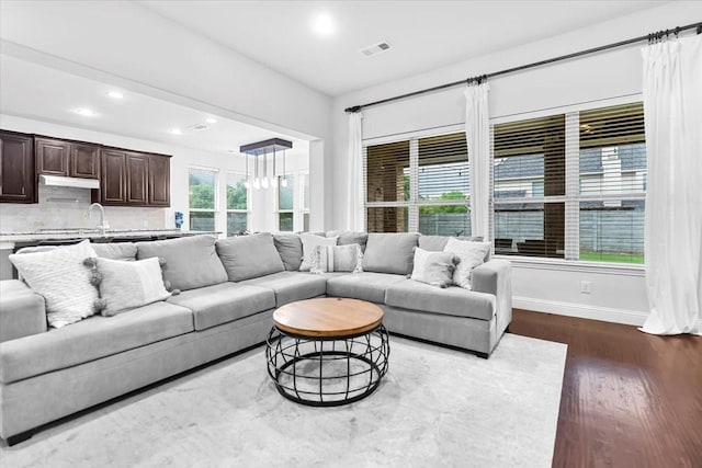 living room with visible vents, baseboards, recessed lighting, a chandelier, and dark wood finished floors