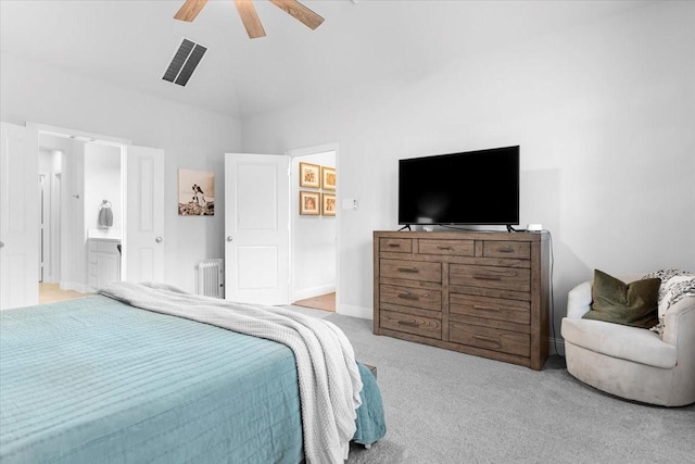 bedroom with a ceiling fan, visible vents, radiator heating unit, carpet flooring, and ensuite bath