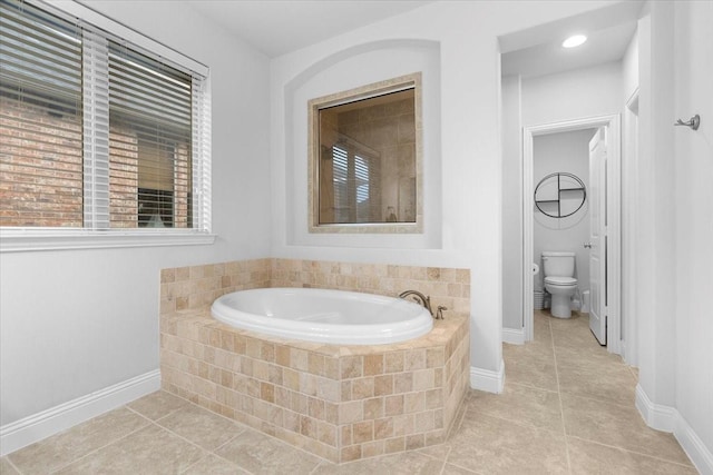 full bathroom with tile patterned flooring, baseboards, a bath, and toilet