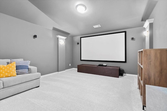 carpeted home theater room featuring baseboards and vaulted ceiling