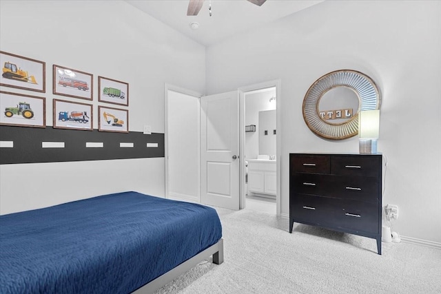 carpeted bedroom featuring a sink, baseboards, ensuite bathroom, and ceiling fan