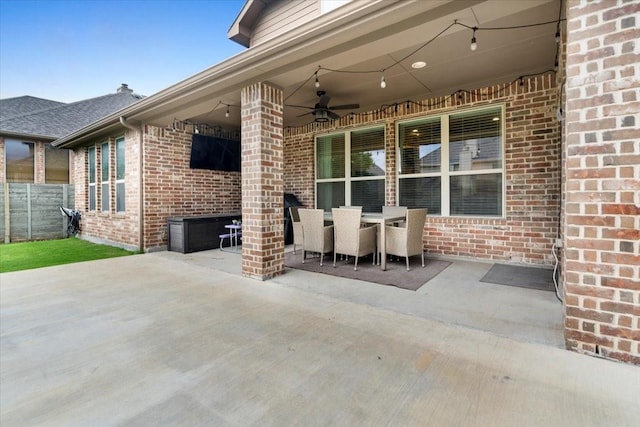 view of patio with ceiling fan, fence, and outdoor dining space