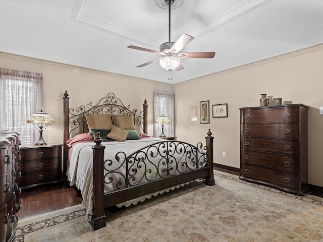 bedroom with crown molding, baseboards, ceiling fan, and wood finished floors