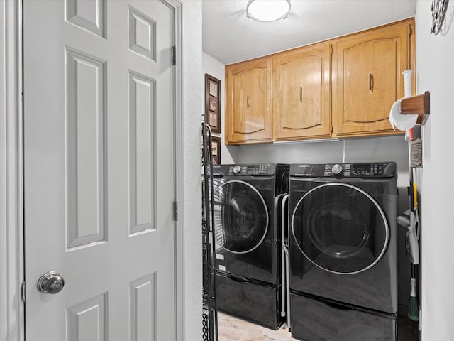 washroom with cabinet space and independent washer and dryer
