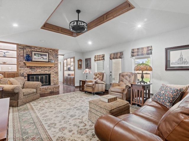 living room featuring a brick fireplace, recessed lighting, and wood finished floors