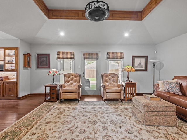 living area with recessed lighting, baseboards, wood finished floors, and lofted ceiling