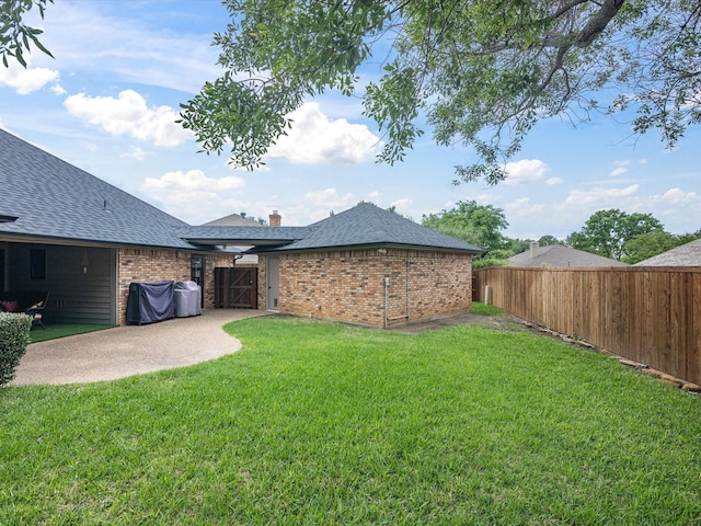 view of yard with fence and a patio